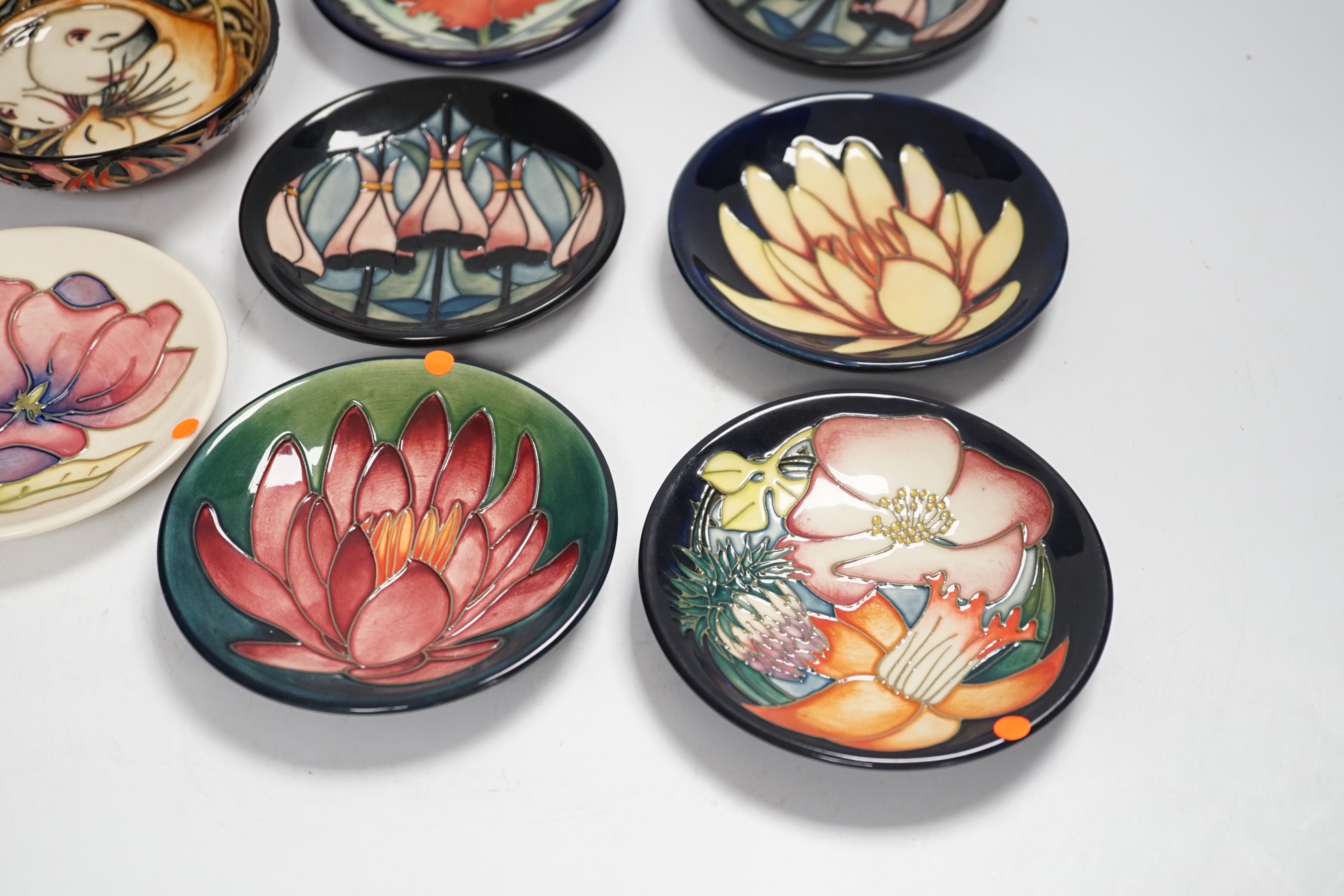 Seven Moorcroft floral dishes, two with Kerry Goodwin stamp to the base and a dormouse bowl designed by Emma Bossons, limited edition 14/100, 12cm in diameter